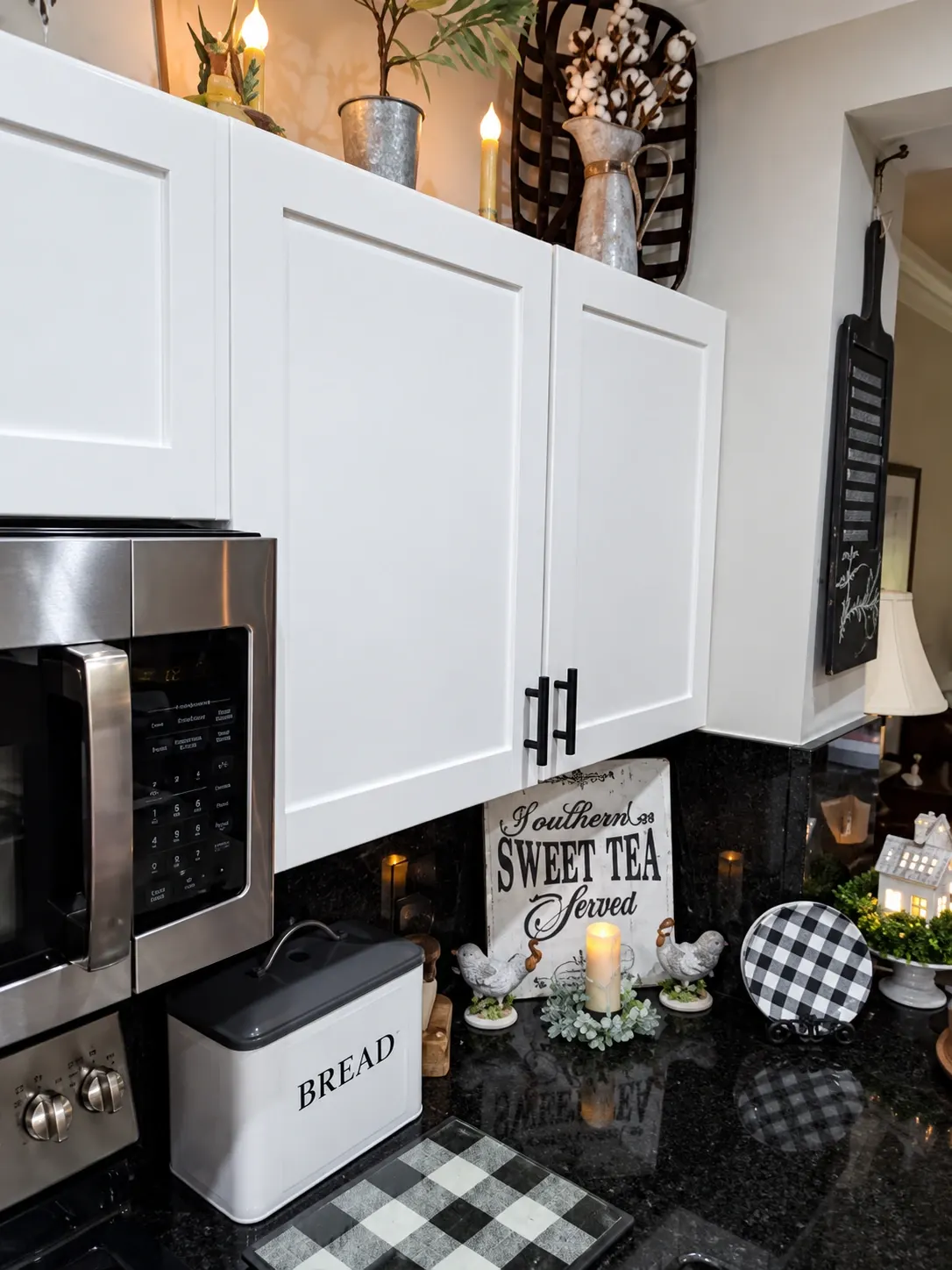 Modern kitchen with white cabinets, black granite countertop, and stainless steel appliances